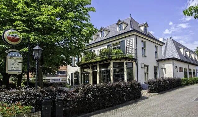 Grand Café Eemland in Eemnes: wit pand met erker en terras onder een boom